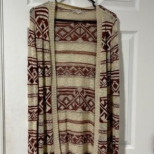 This is a medium red and cream cardigan